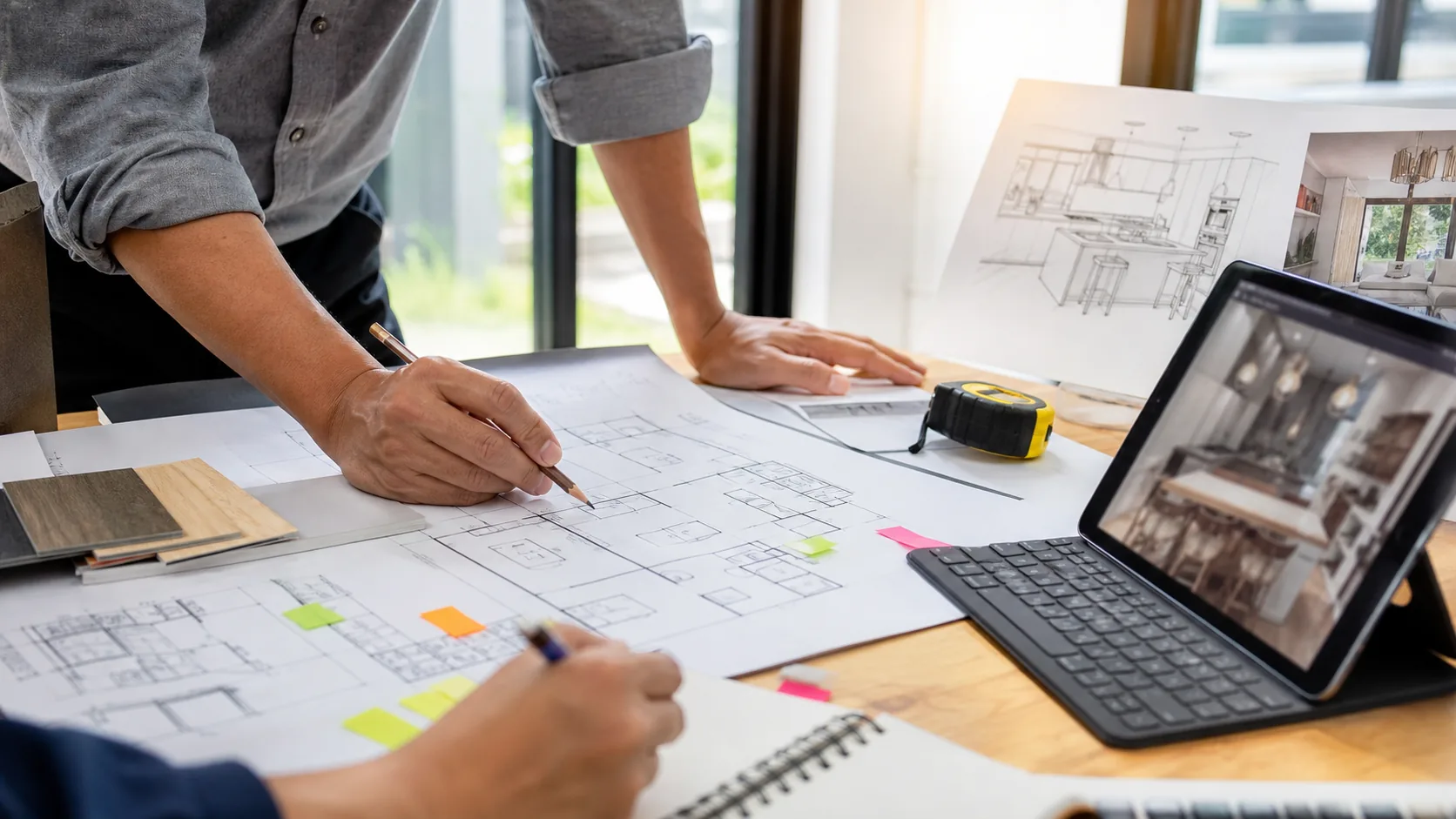 Homeowner reviewing remodel scope and permit questions with construction plans.